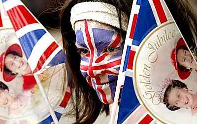 Lina Sultana, 8, has her face painted with the Union Jack to celebrate Britain's Queen Elizabeth II's Golden Jubilee at a street party on Jubilee Street in Stepney in the East End of London.