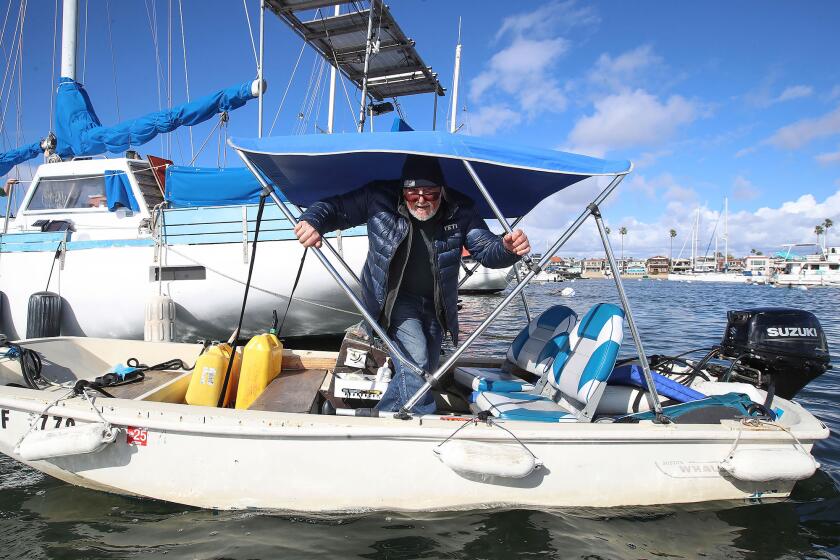 Resident Mike Gauthier goes ashore in his small motor boat in Newport Harbor. She and her husband Mike live in their live-aboard vessel in Newport Harbor in Newport Beach. The Newport Beach Harbor Commission is looking at a proposal that may increase the rental rates for the public moors out in Newport Harbor. The proposal may significantly affect those who are of lower income and those who live in their boats in the harbor.