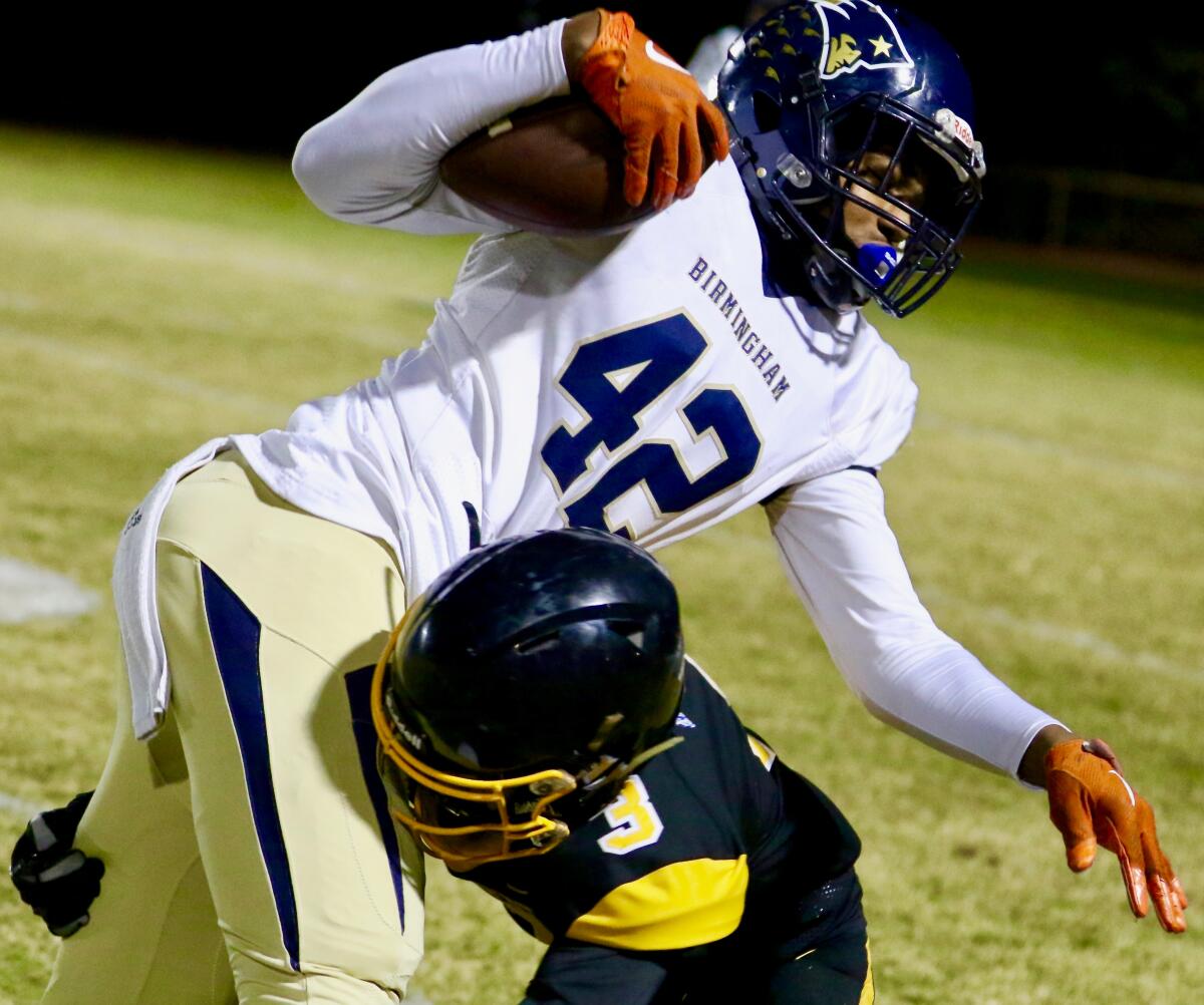 Birmingham sophomore receiver Arlis Boardingham is tackled by a San Pedro defender after a reception in the City Section Open Division semifinal on Nov. 22, 2019.