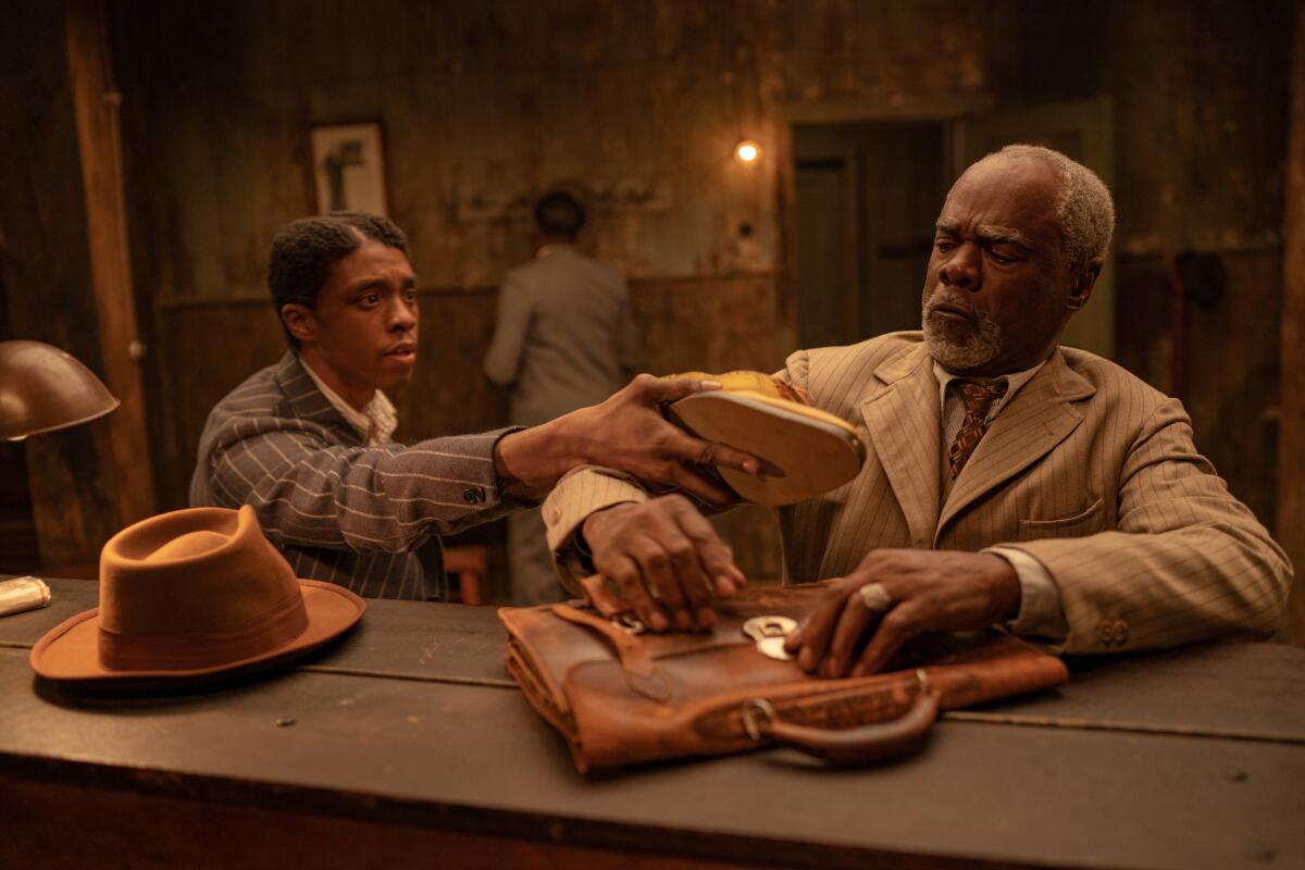 Chadwick Boseman as Levee, and Glynn Turman as Toledo. 