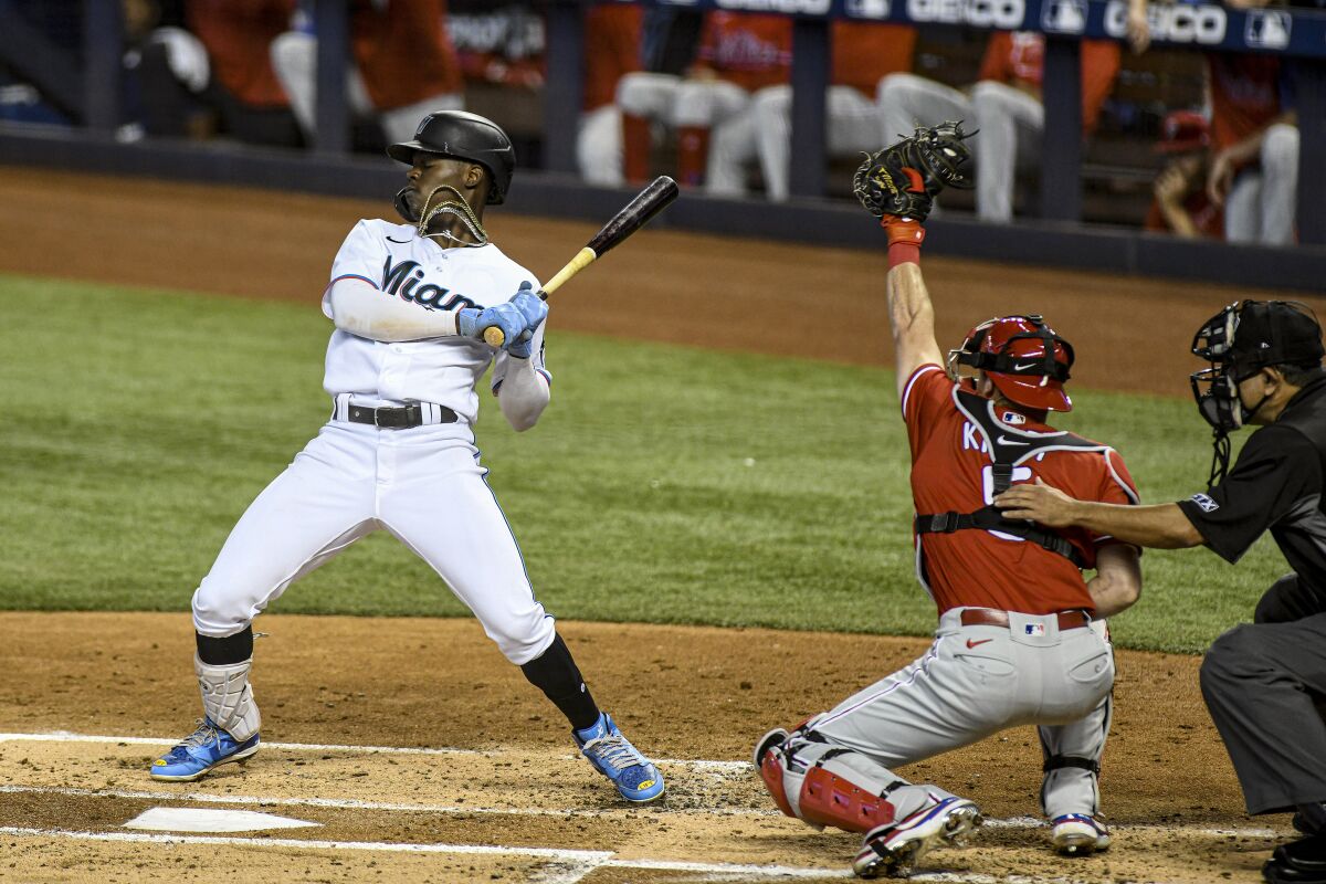 Miami Marlins' Jazz Chisholm Jr. avoids a wild pitch during the first inning of a baseball game against the Philadelphia Phillies, Sunday, Oct. 3, 2021, in Miami. (AP Photo/Gaston De Cardenas)