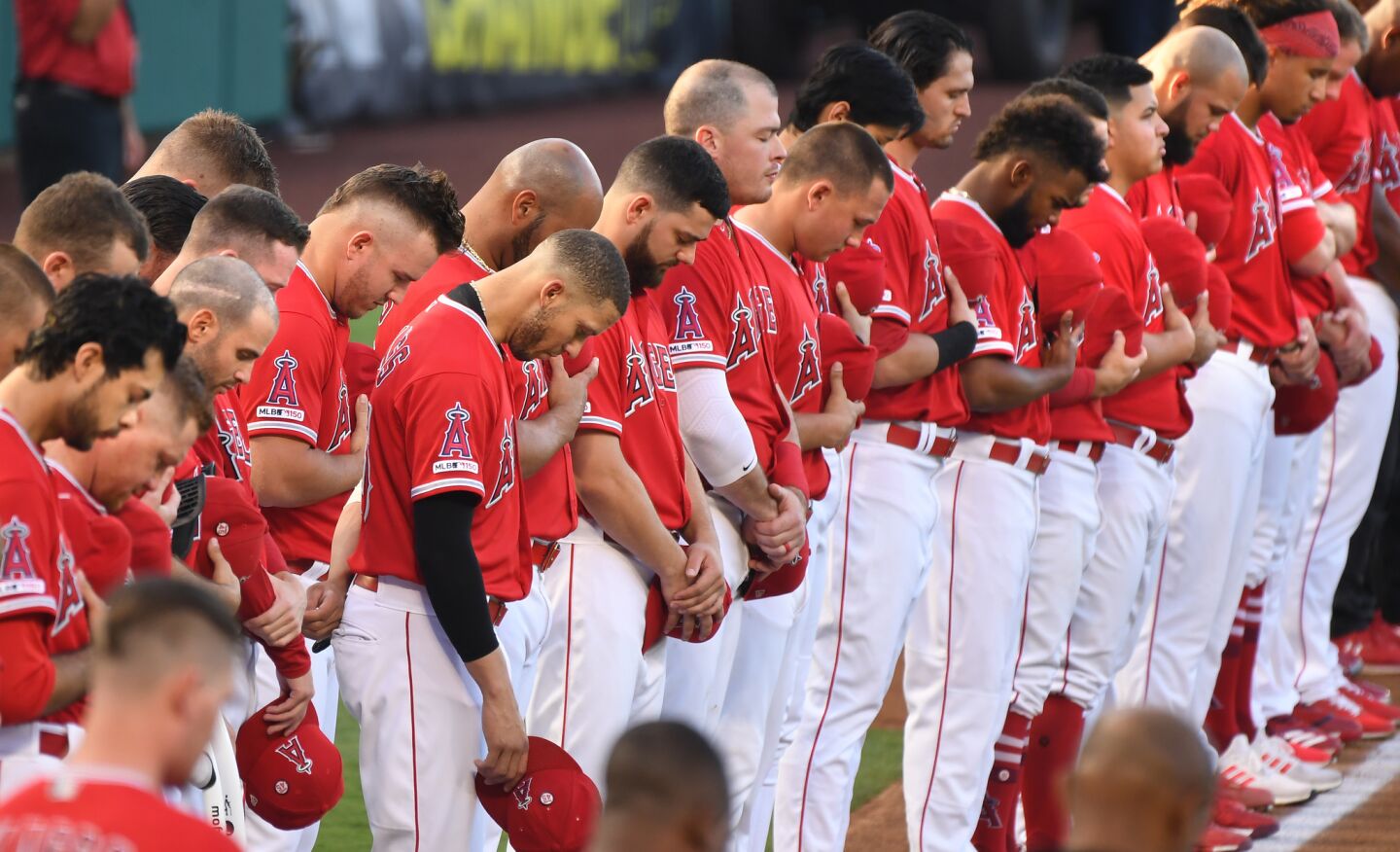 Angel players bow there heads for teammate Tyler Skaggs during a moment of silence.