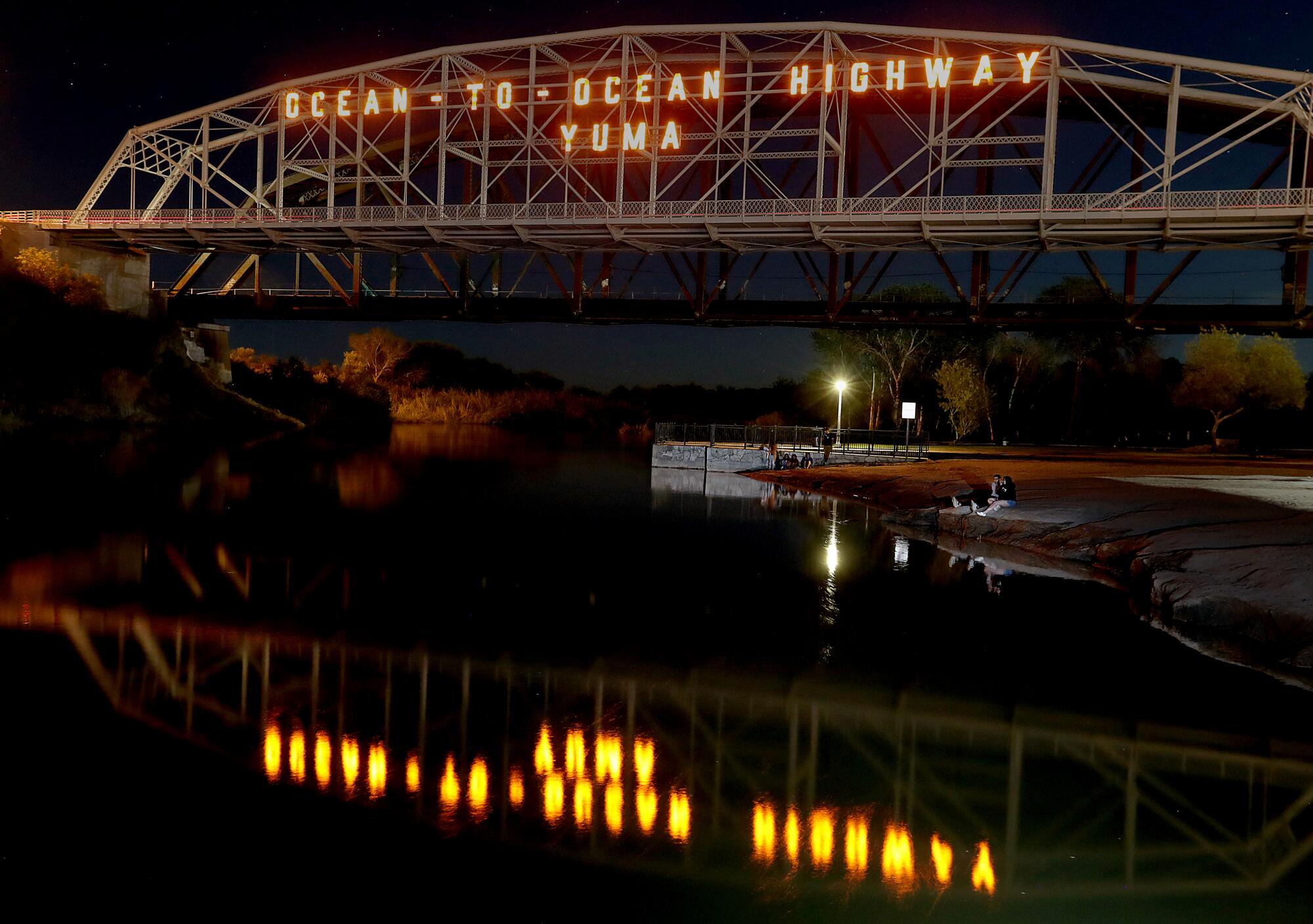 Visitors to Gateway Park in Yuma sit under the Ocean-to-Ocean Bridge, which spans the Colorado River