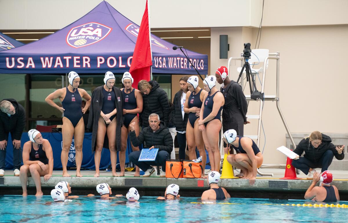 The Team USA women's water polo team talks strategy against Team China at Long Beach City College on Monday.