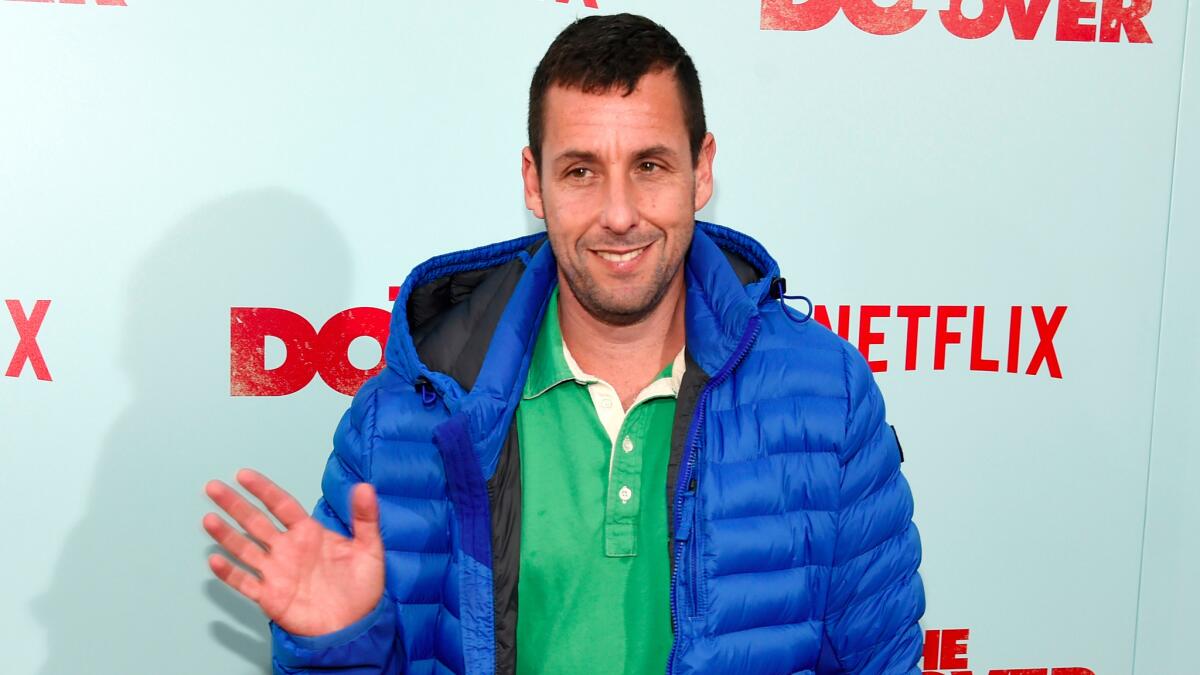 Adam Sandler, a cast member in "The Do-Over," waves to photographers at the premiere of the film at the Regal LA Live theaters on May 16, 2016, in Los Angeles. (Chris Pizzello / Invision/Associated Press)