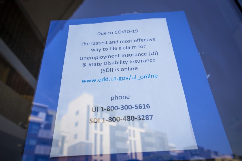A sign gives instructions on applying for unemployment