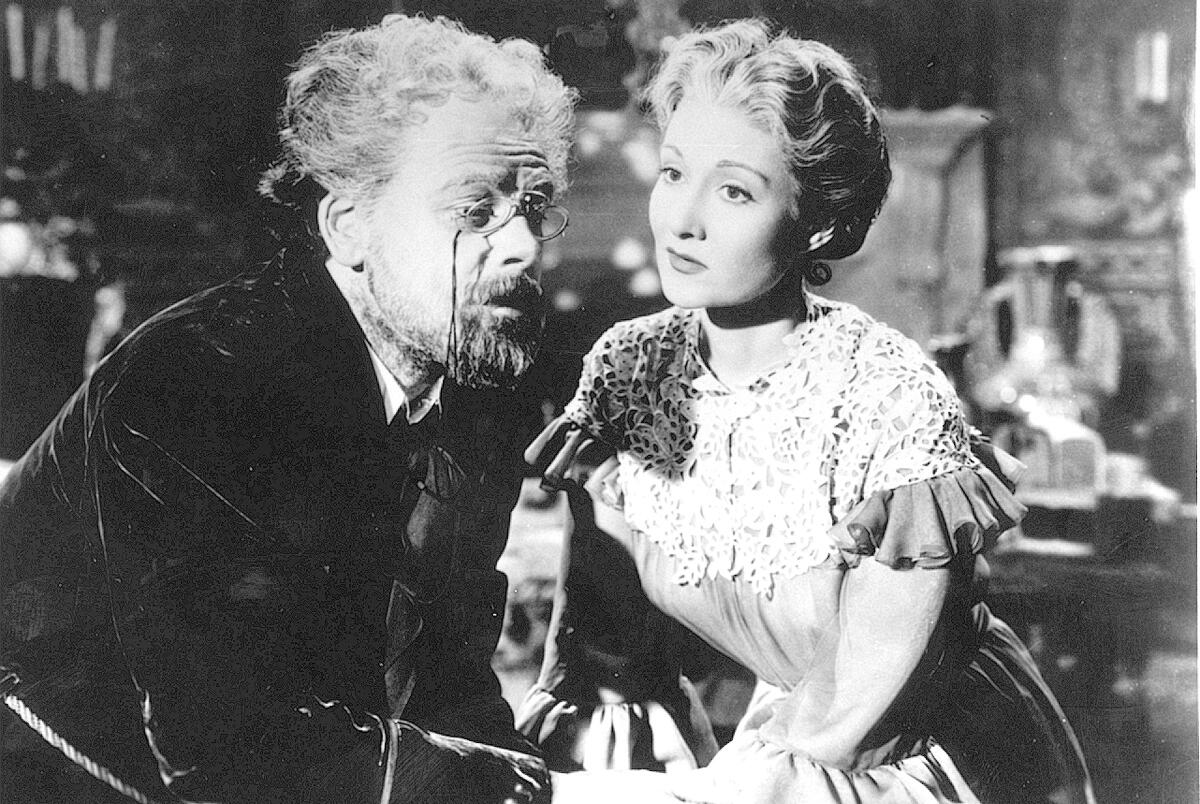 Paul Muni, left, and Gloria Holden in “The Life of Emile Zola.” (1937)