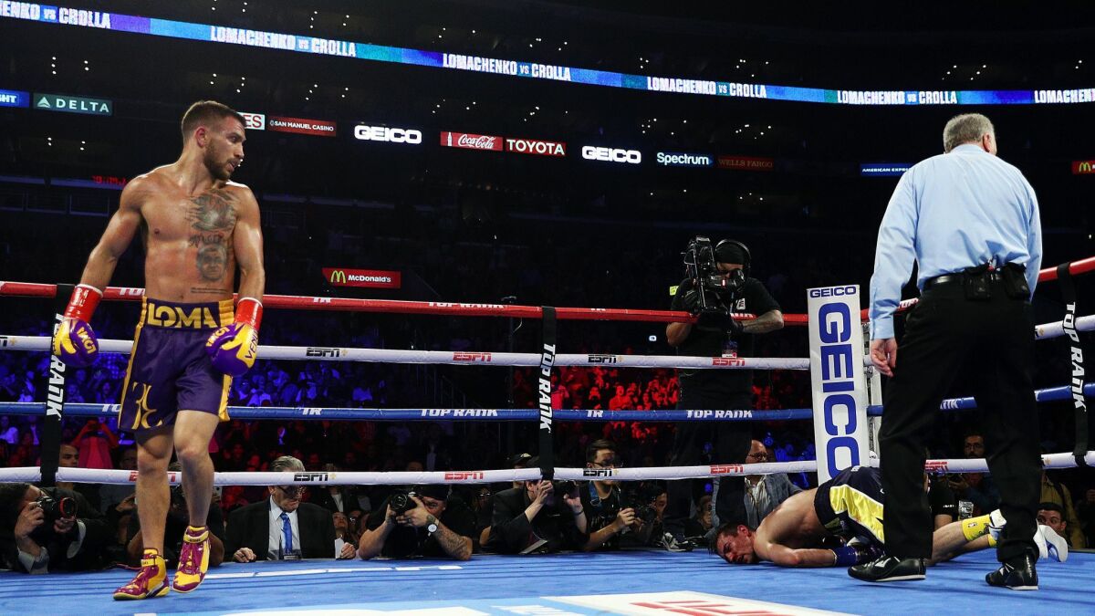 Vasiliy Lomachenko knocks out Anthony Crolla during their WBA/WBO lightweight title bout at Staples Center.