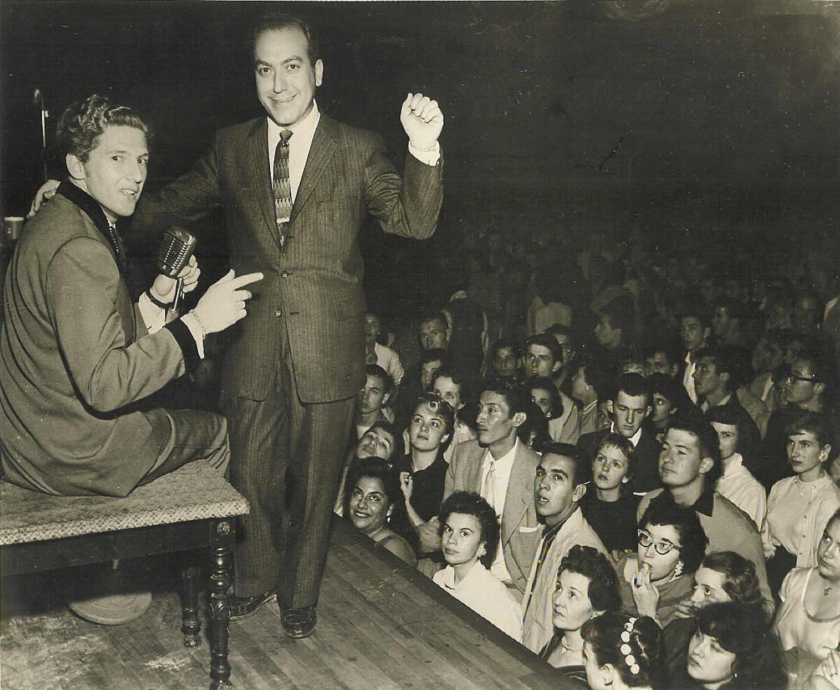 Art Laboe, right, and Jerry Lee Lewis onstage before a pack crowd in L.A.