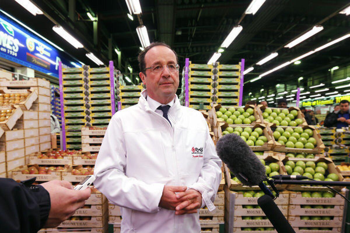 French President Francois Hollande speaks to journalists as he visits a wholesale market in Rungis near Paris on Thursday.