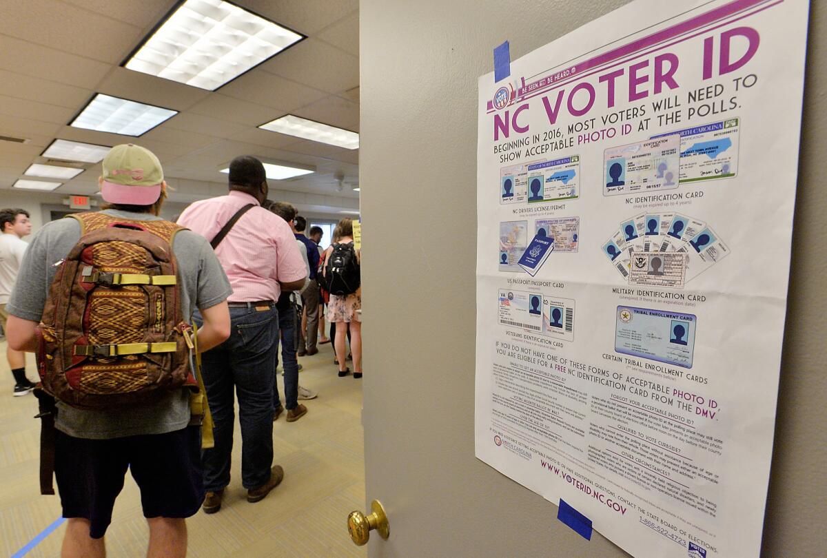 North Carolina State University students wait in line to vote in the primaries in Raleigh, N.C., in March. The primary was the state's first with its new voter ID law, which excludes student ID cards as acceptable identification at the polls. Wake County, where the college is located, was among the counties with the highest use of provisional ballots, which require approval by the state board of elections after being cast to count. A federal court later struck the law down as being severely discriminatory.