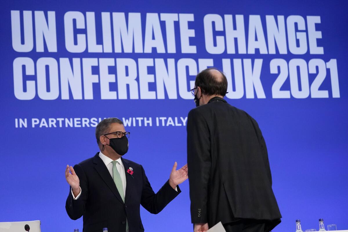 Alok Sharma, left, president of the COP26 summit, at a plenary session Saturday in Glasgow, Scotland
