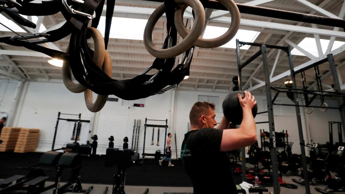 Coaches and club members participate in a Work class at the Pharos Athletic Club in Echo Park.