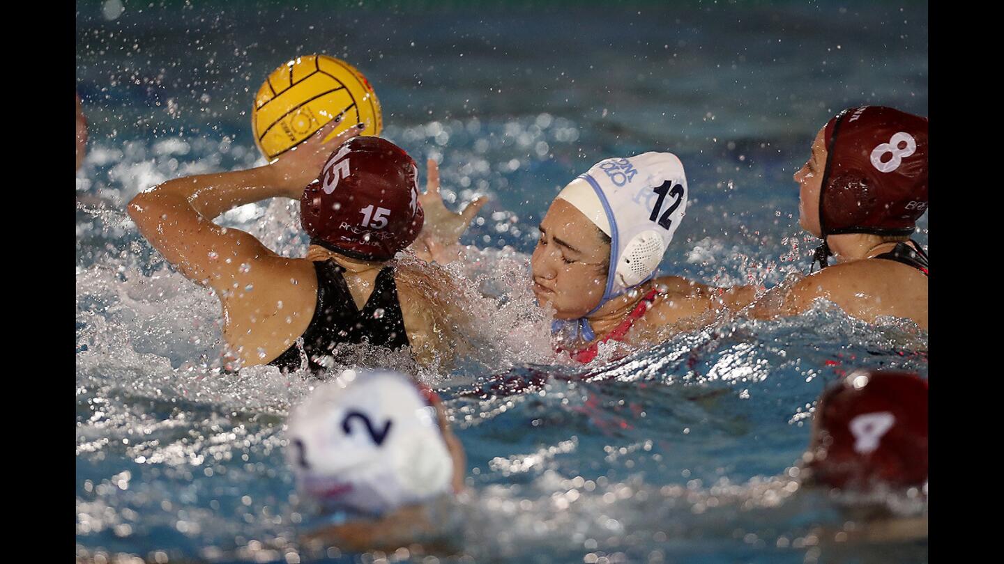 Corona del Mar High's Chloe Harbilas (12) loses the ball to Laguna Beach's Claire Kelly (15) during the first half in the fifth-place match of the CIF Southern Section Division 1 playoffs on Thursday in Newport Beach.