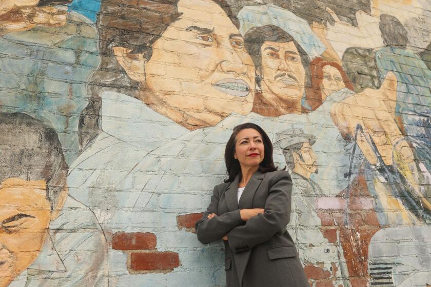 Anaheim, CA - May 23: Natalie Rubalcava poses for a portrait in front of the Memories of the Past, Images of the Present mural on Thursday, May 23, 2024 in Anaheim, CA. Rubalcava faces a recall in one week after being named in a corruption report detailing corporate influence in Anaheim politics. (Michael Blackshire / Los Angeles Times)