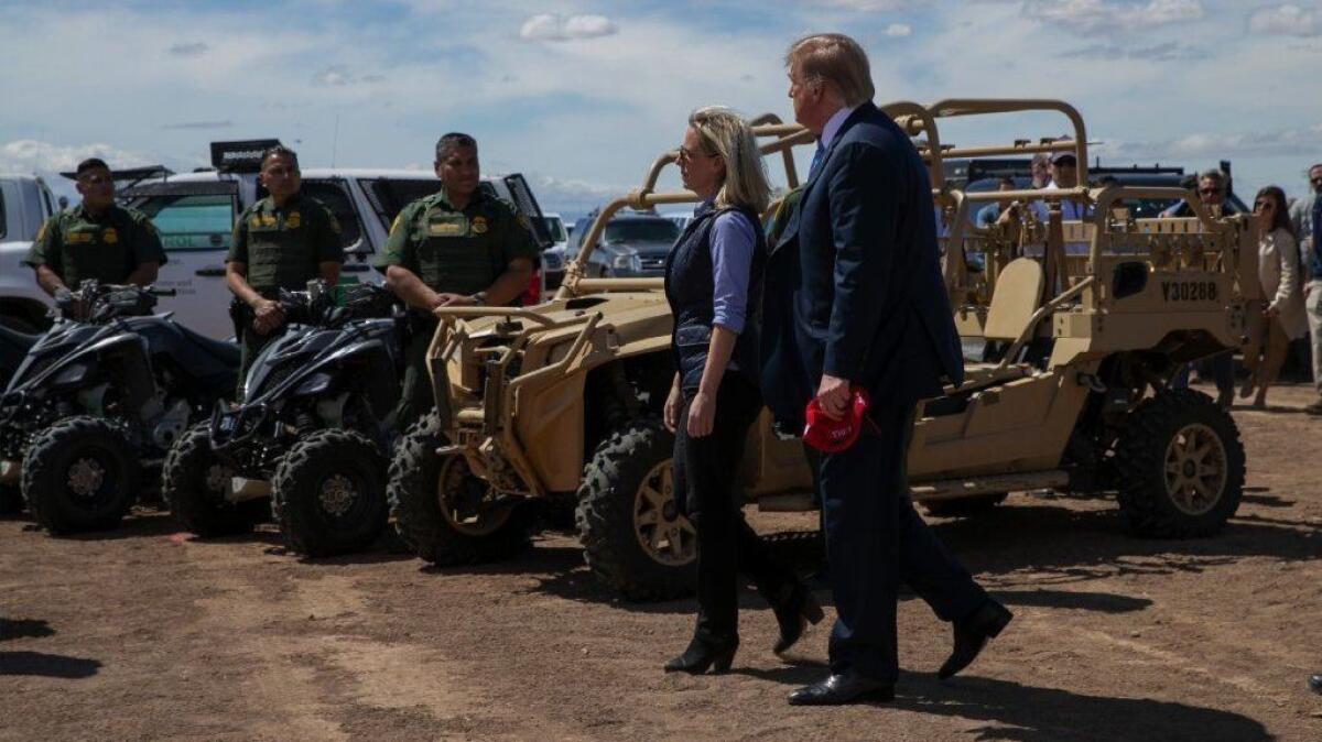 President Trump walks with Homeland Security Secretary Kirstjen Nielsen in Calexico, Calif., on Friday. She was ousted from her post two days later.