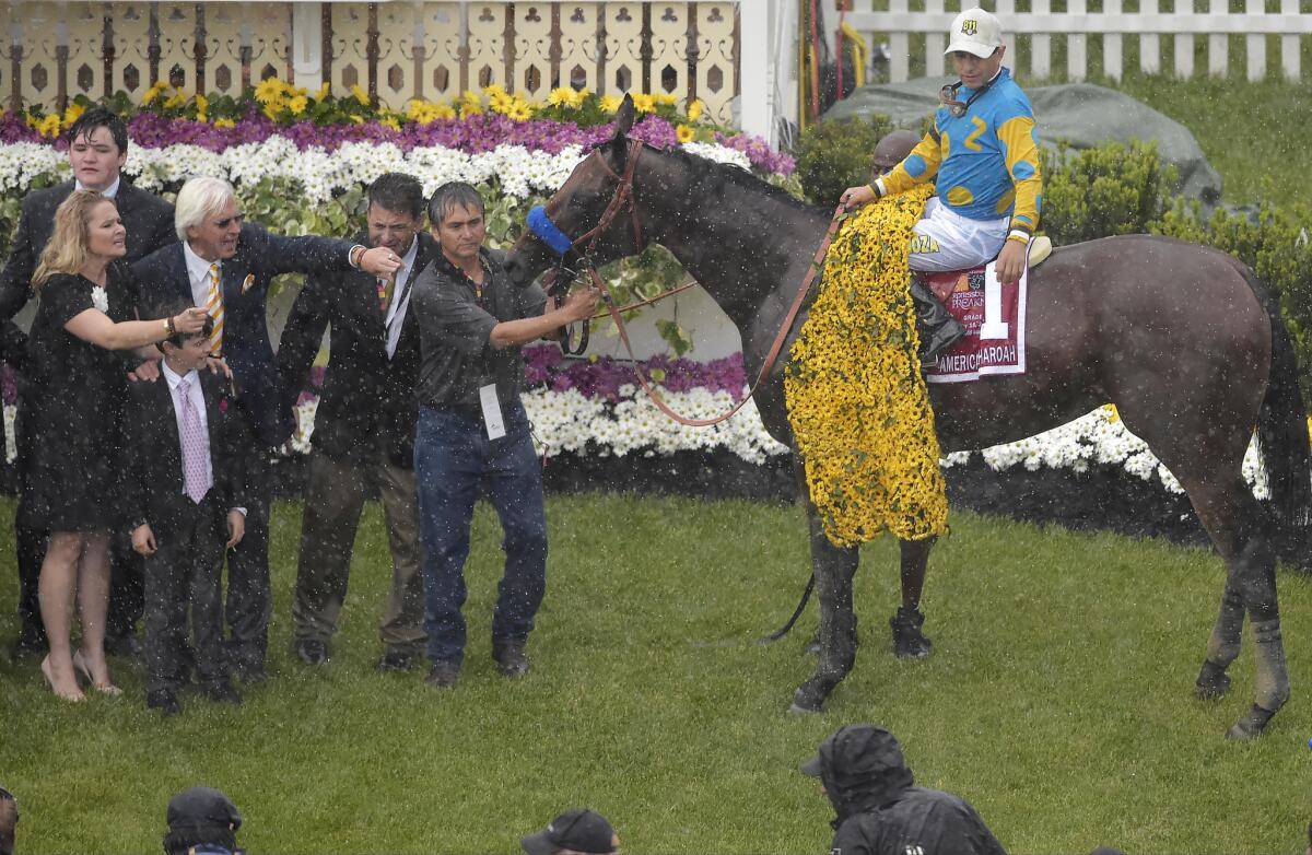 Victor Espinoza and his mount American Pharaoh pose for photos after winning the 140th Preakness Stakes horse race at Pimlico Race Course in May. Pharoah, the first Triple Crown winner in 37 years, can be seen at Del Mar during its race season, which begins Thursday.