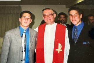 Vince Busalacchi (on right) and Joey Busalacchi (on left) with Father Louie Solcia at their confirmation in 1999.
