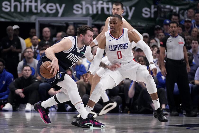 Dallas Mavericks guard Luka Doncic, left, works against Los Angeles Clippers guard Russell Westbrook (0) during the first half in Game 2 of an NBA basketball first-round playoff series in Dallas, Friday, April 26, 2024. (AP Photo/Tony Gutierrez)