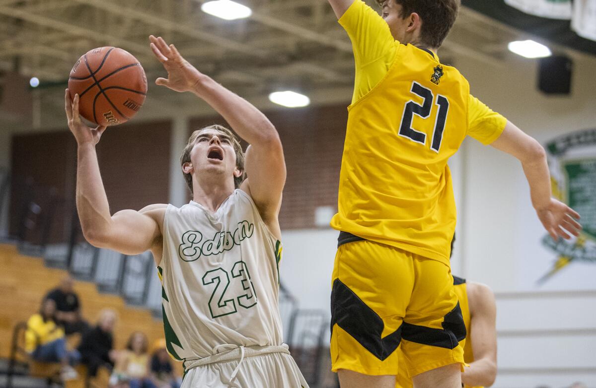 Edison's Tucker Tripp goes up for a shot against Mission Bay's Charlie Hutchison during Tuesday's game.