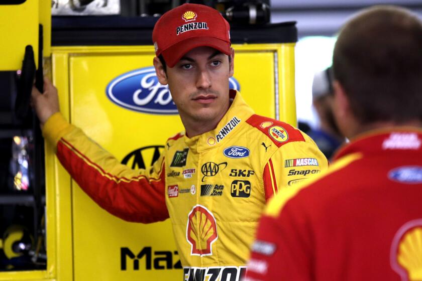 Driver Joey Logano talks with his crew as he prepares for a practice session for Sunday's NASCAR Cup Series 301 auto race at the New Hampshire Motor Speedway in Loudon, N.H., Saturday, July 15, 2017.(AP Photo/Charles Krupa)