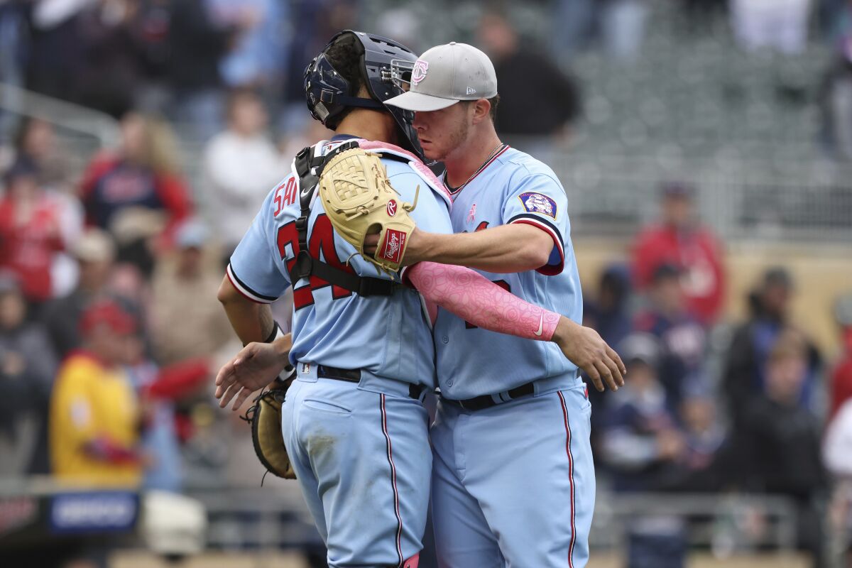 Minnesota Twins relief pitcher Emilio Pagan, right, celebrates with catcher Gary Sanchez (24) after defeating the Oakland Athletics in a baseball game Sunday, May 8, 2022, in Minneapolis. (AP Photo/Stacy Bengs)