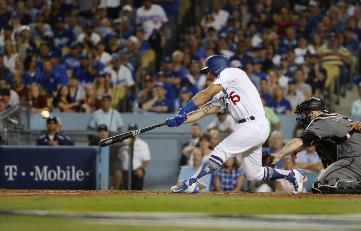 Austin Barnes hits a two-run doube to give the Dodgers a 6-2 led in the fifth inning over the Diamondbacks in Game 2 of the National League division series on Oct. 7.