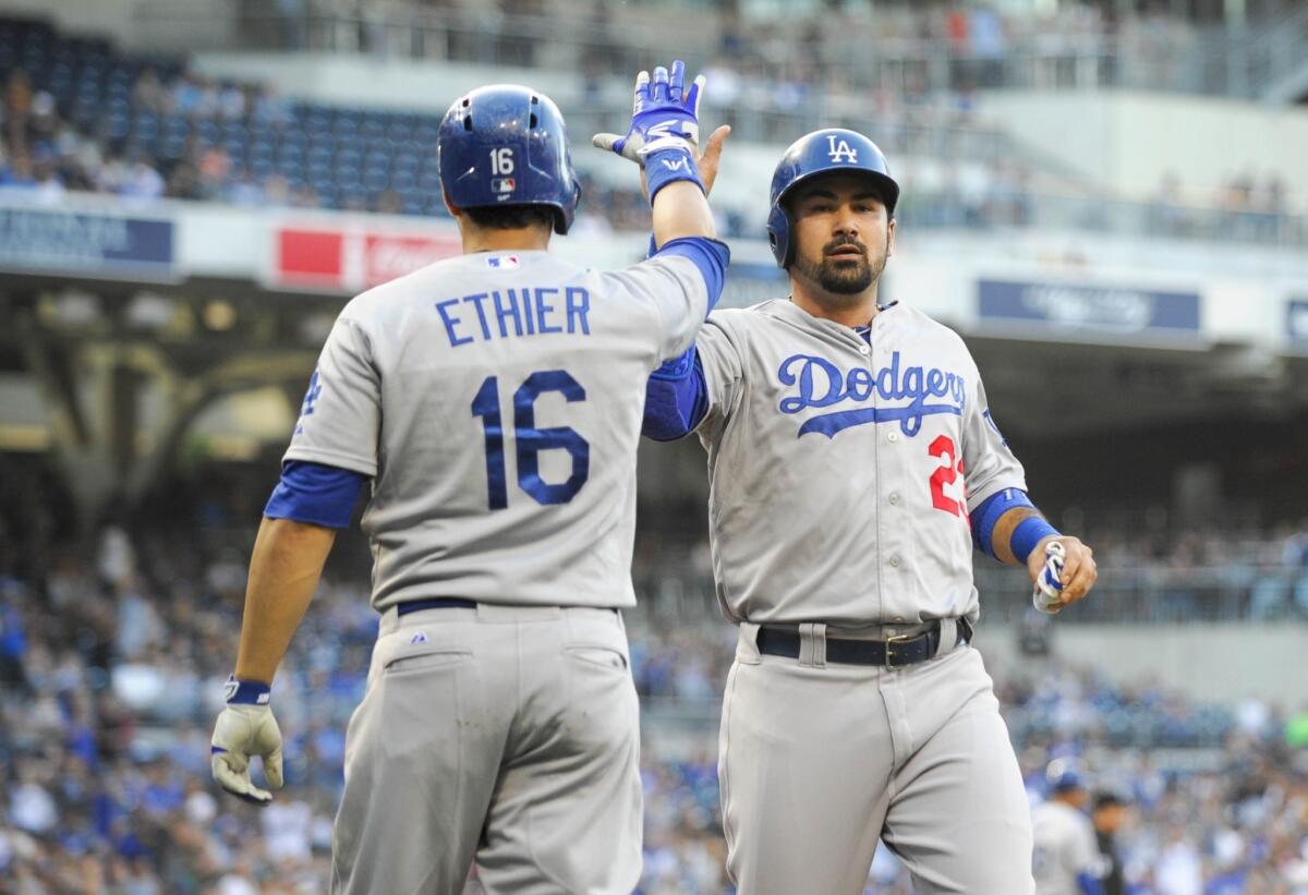 Adrian Gonzalez is congratulated by Andre Ethier after scoring inthe first inning of a game against the San Diego Padres.