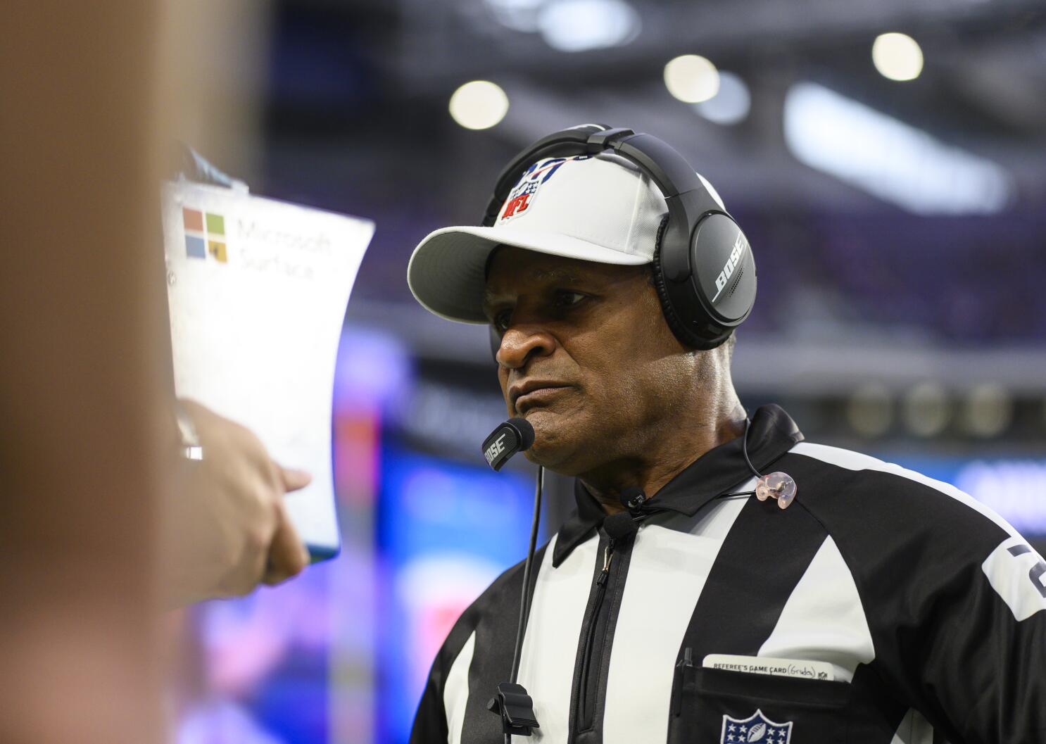 NFL referees discuss a penalty flag thrown during the second half of an NFL  playoff game betwee …