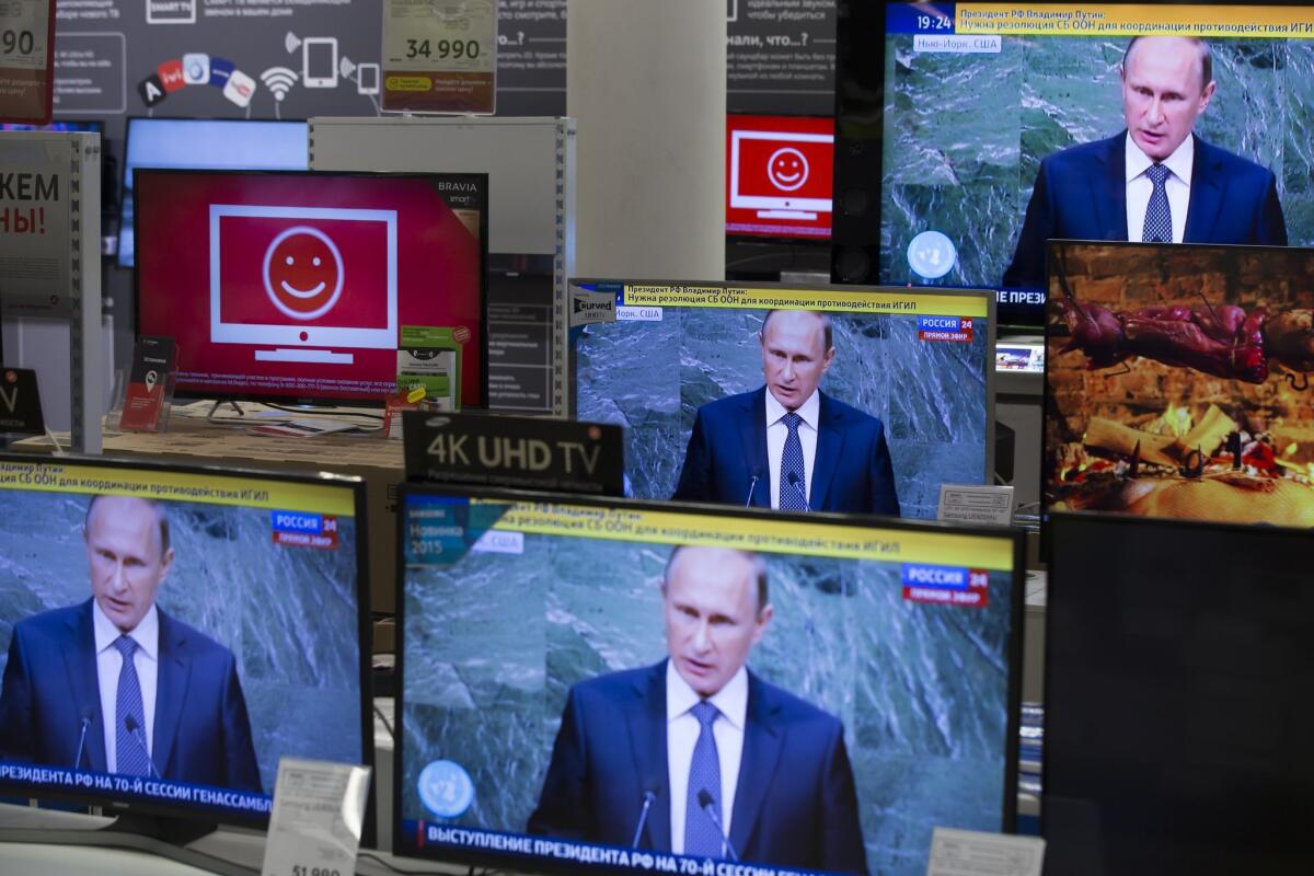 Television screens at an electronics shop in Moscow show Russian President Vladimir Putin at the United Nations General Assembly Sept. 28, 2015.