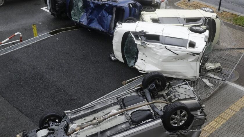 A 2018 typhoon overturned cars in Osaka. When an airport flooded, a Taiwanese official was criticized for not having made arrangements to rescue stranded tourists.