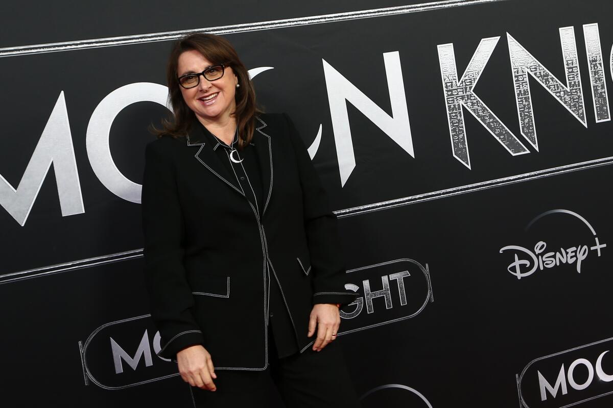 A smiling Victoria Alonso wearing a black suit