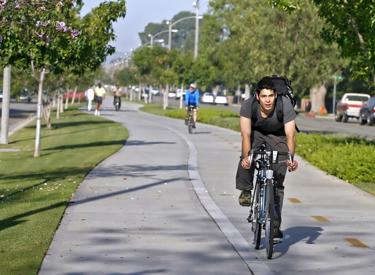 Rick Kogler, 26 of Canoga Park, rides his bike to work on the Chandler Bikeway near Mariposa St. on National Bike To Work Day, Thursday, May 20, 2010.