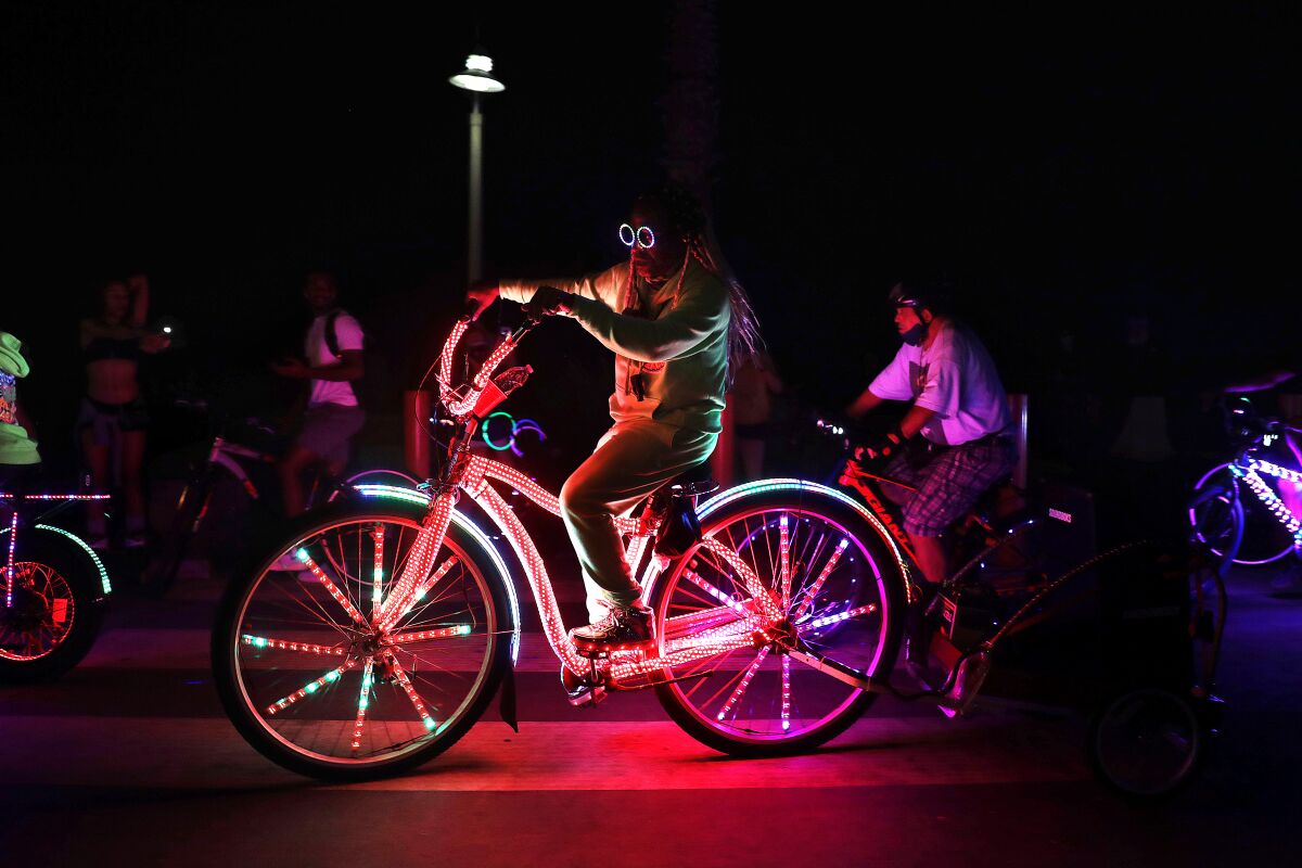 A group of cyclists participate in the Venice Electric Light Parade