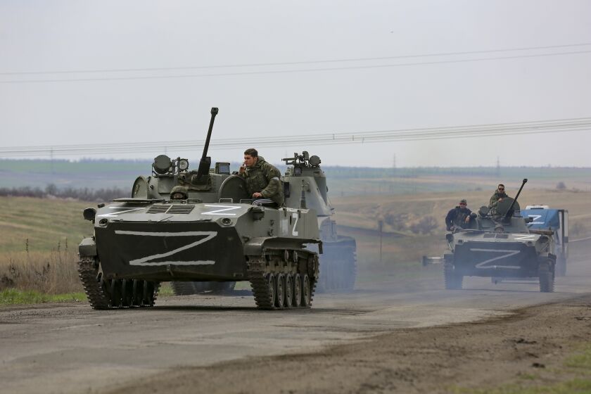 FILE - Russian military vehicles move on a highway in an area controlled by Russian-backed separatist forces near Mariupol, Ukraine, April 18, 2022. (AP Photo/Alexei Alexandrov, File)