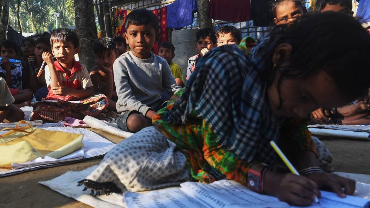 Rohingya Hindu children from Myanmar attend school at a refugee camp in Bangladesh in November.