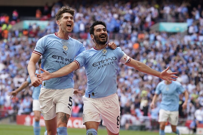 Manchester City's Ilkay Gundogan, right, celebrates after scoring his side's second goal during the English FA Cup final soccer match between Manchester City and Manchester United at Wembley Stadium in London, Saturday, June 3, 2023. (AP Photo/Dave Thompson)