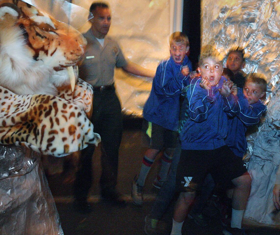 Jacob Shane, of Crescenta Valley, jumps back for cover with his 10 and 11 year old soccer teammates from the Crescenta Valley Fountains after being frightened by a big tiger that jumped at them at the Crescenta Valley Sheriff's Station Haunted Jail in La Crescenta on Thursday, October 29, 2015. The $8 experience includes a maze that takes the guests through the past.