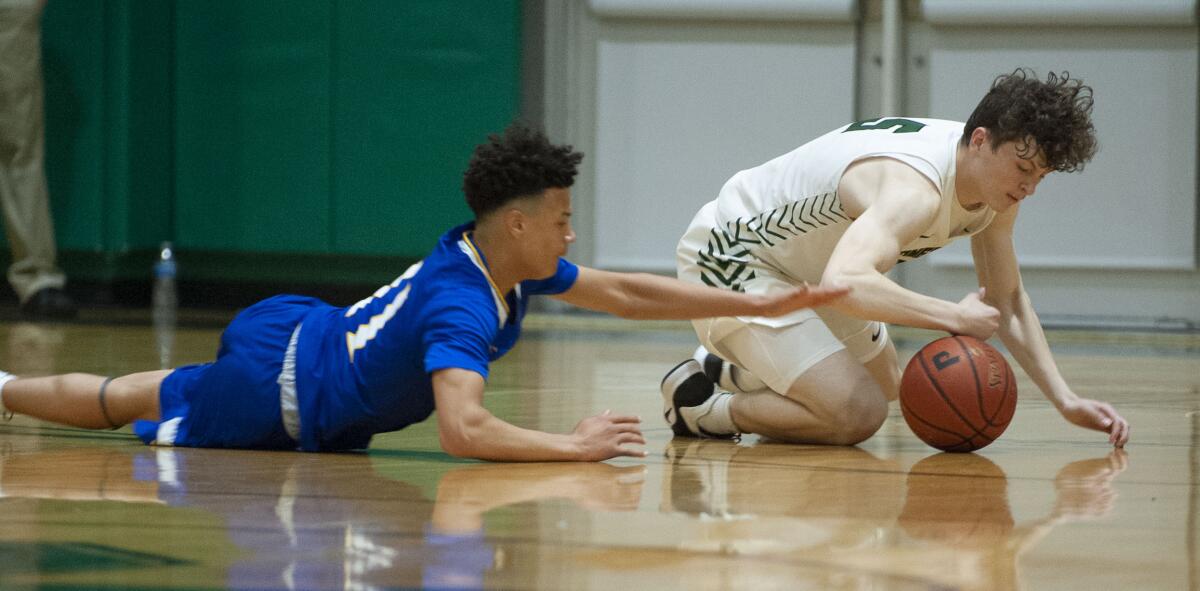 Fountain Valley's Macarhy Morris and Providence's Collin Ferrell scramble for the loose ball during CIF State Division III Southern California Regional semifinal at Providence High. (Photo by Miguel Vasconcellos)