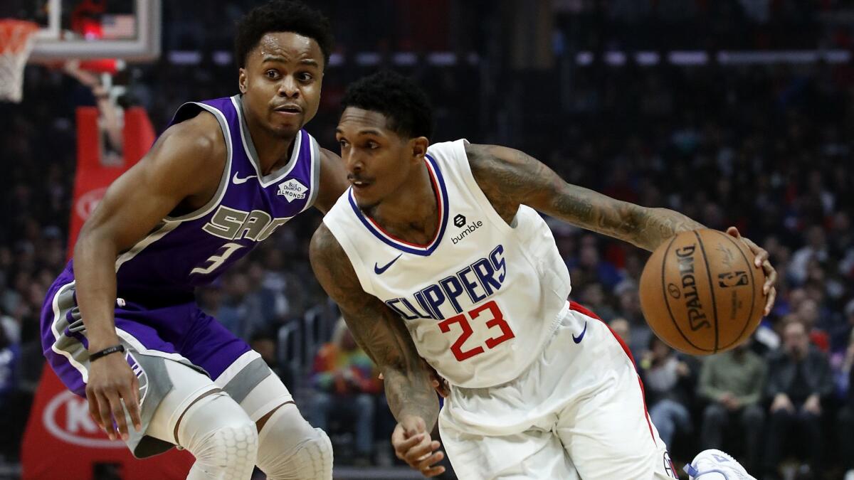 Clippers guard Lou Willimas drives to the basket against Kings guard Yogi Ferrell in the first quarter.