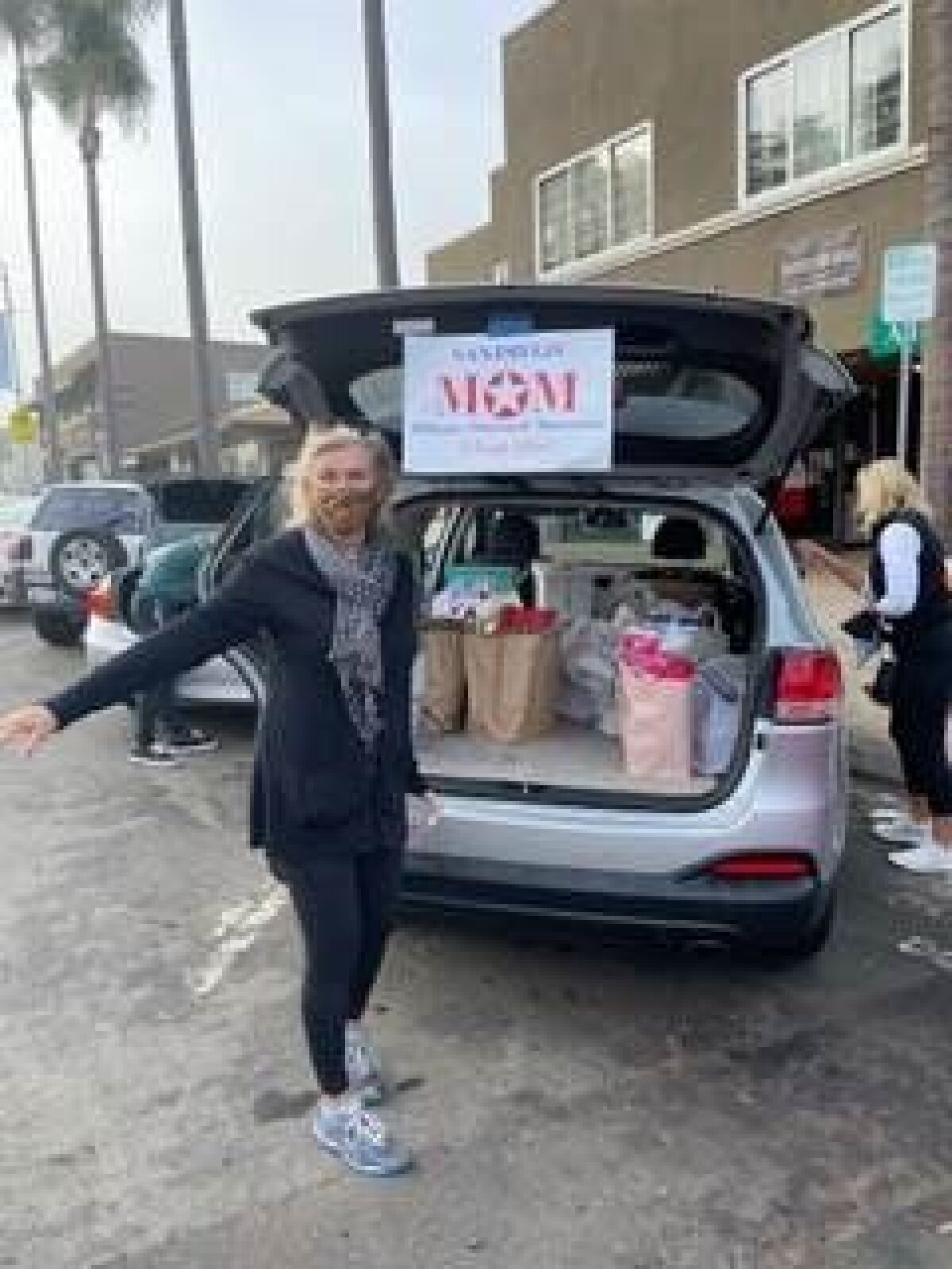 Sally Irwin loads up a haul from the 2020 "Turkey Trot" for San Diego Military Outreach Ministries.