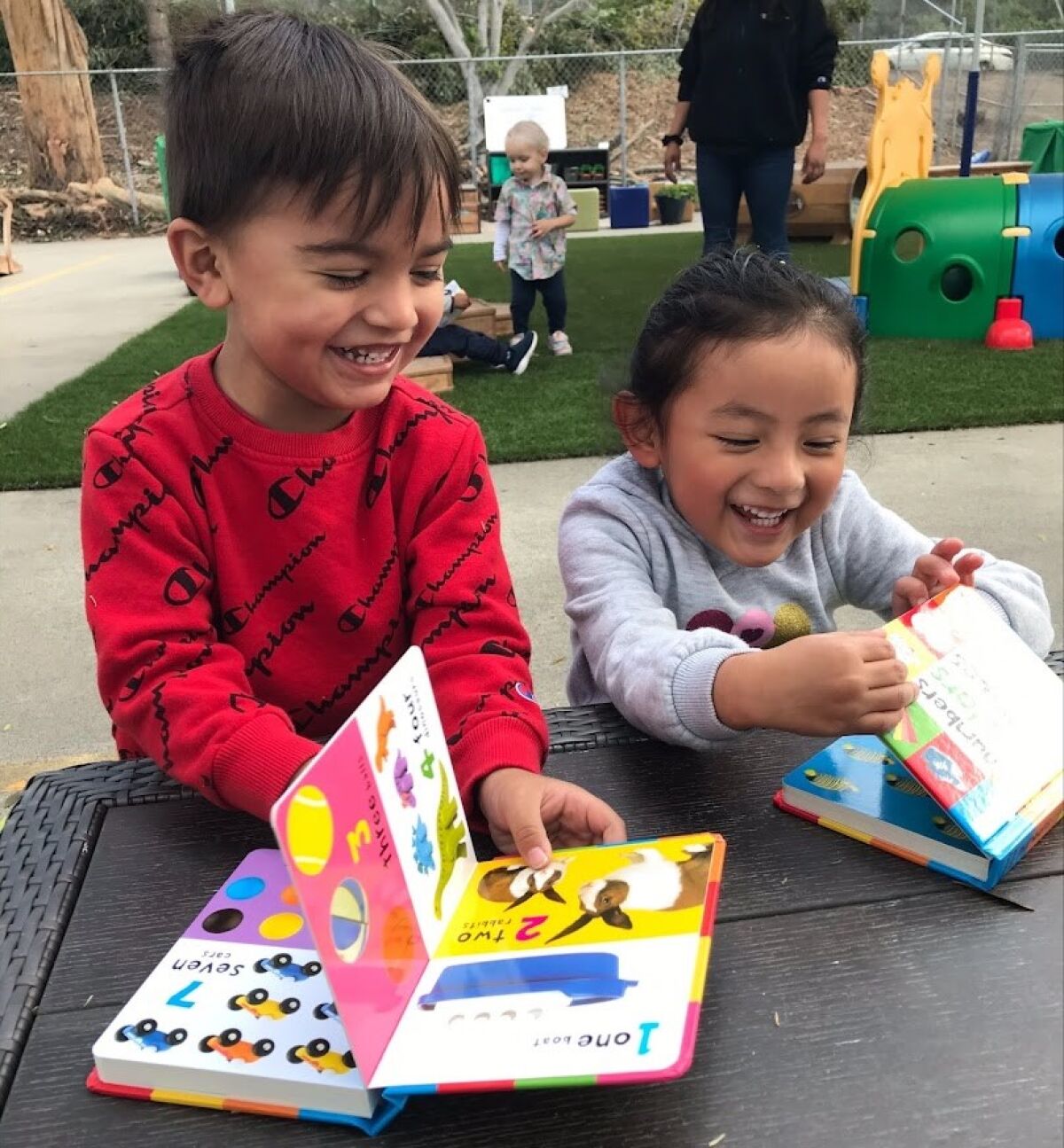 Alexander Anta and Zoe Jimenez from Solana Beach Head Start enjoy free books from Assistance League Rancho San Dieguito.