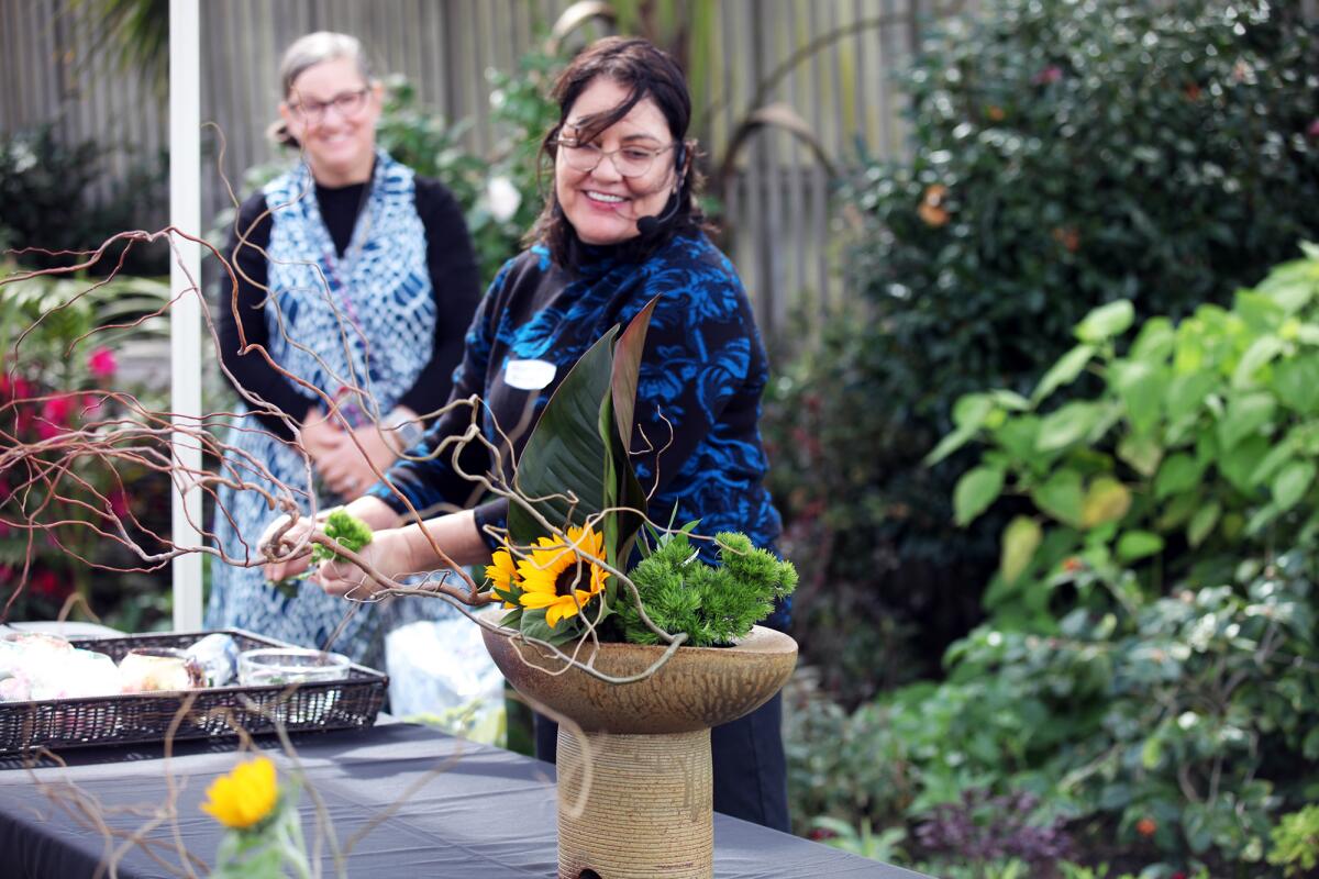 Valeria Brinkers smiles as she finishes her Ikebana arrangement at the 2022 show.