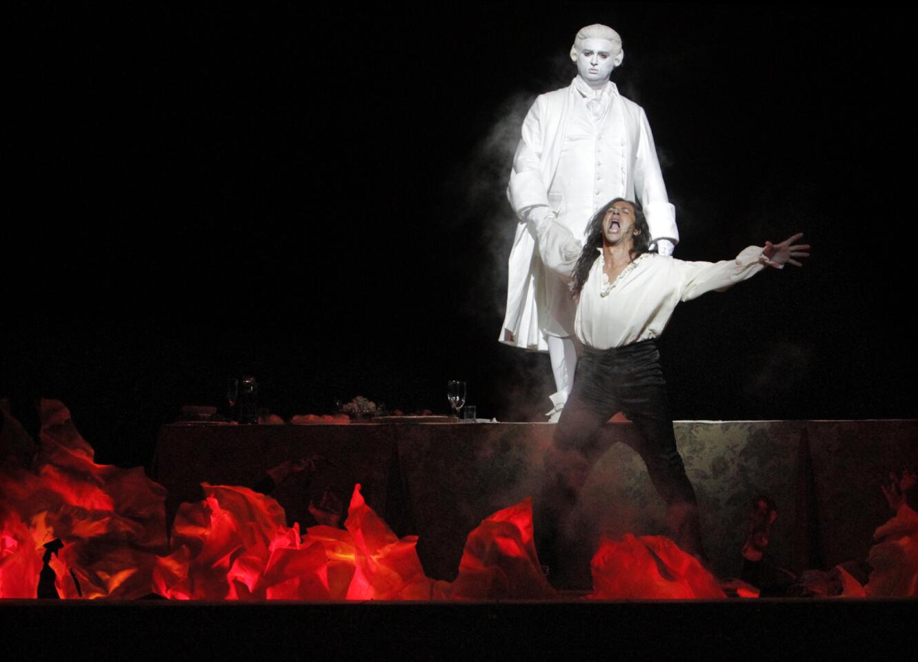 Ildebrando D'Arcangelo, front, as Don Giovanni and Ievgen Orlov as Commendatore at the dress rehearsal of "Don Giovanni" at the Dorothy Chandler Pavilion in Los Angeles.