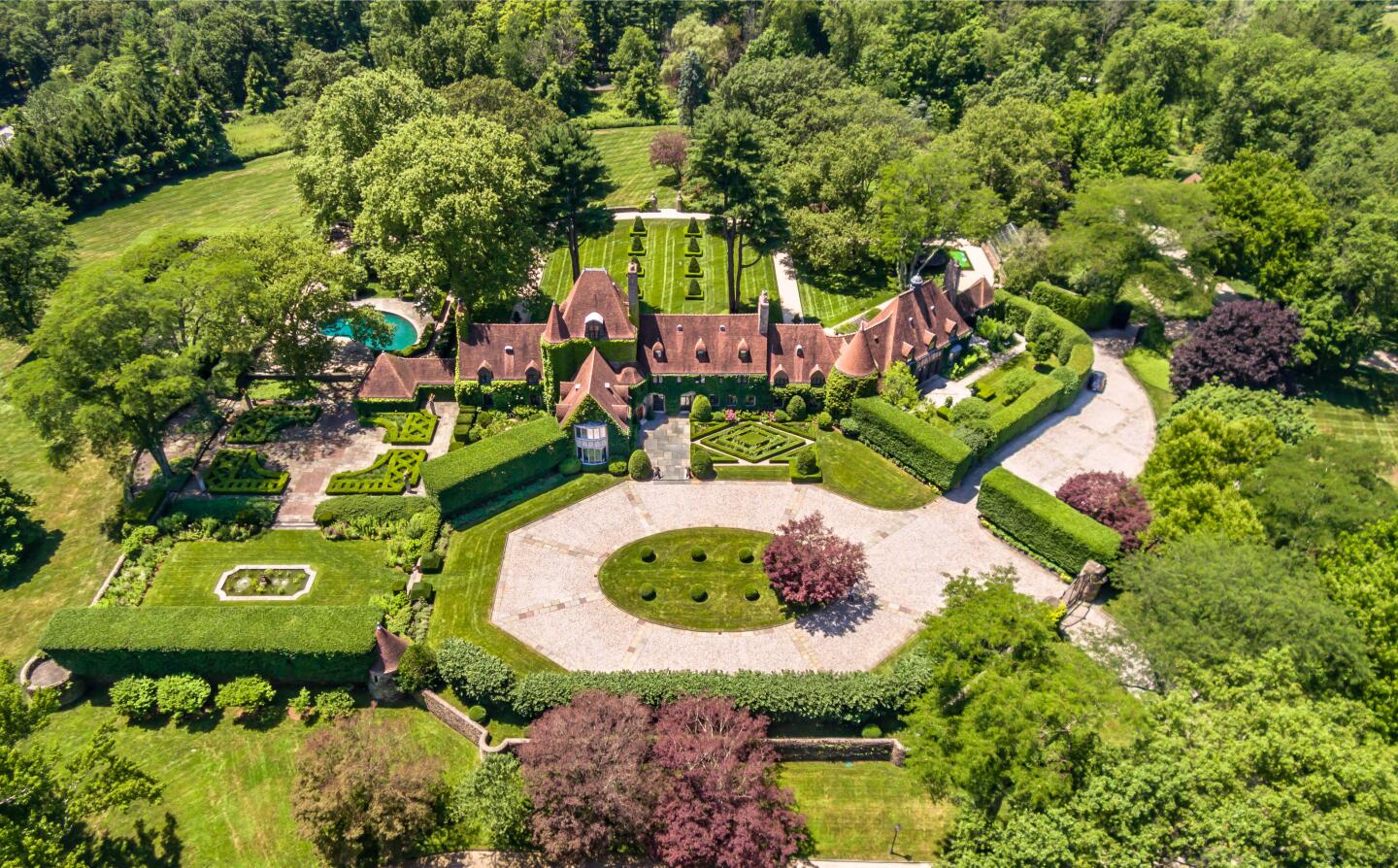 The park-like grounds center on a 13,000-square-foot mansion surrounded by rolling lawns, manicured hedges, water features and a tennis court.