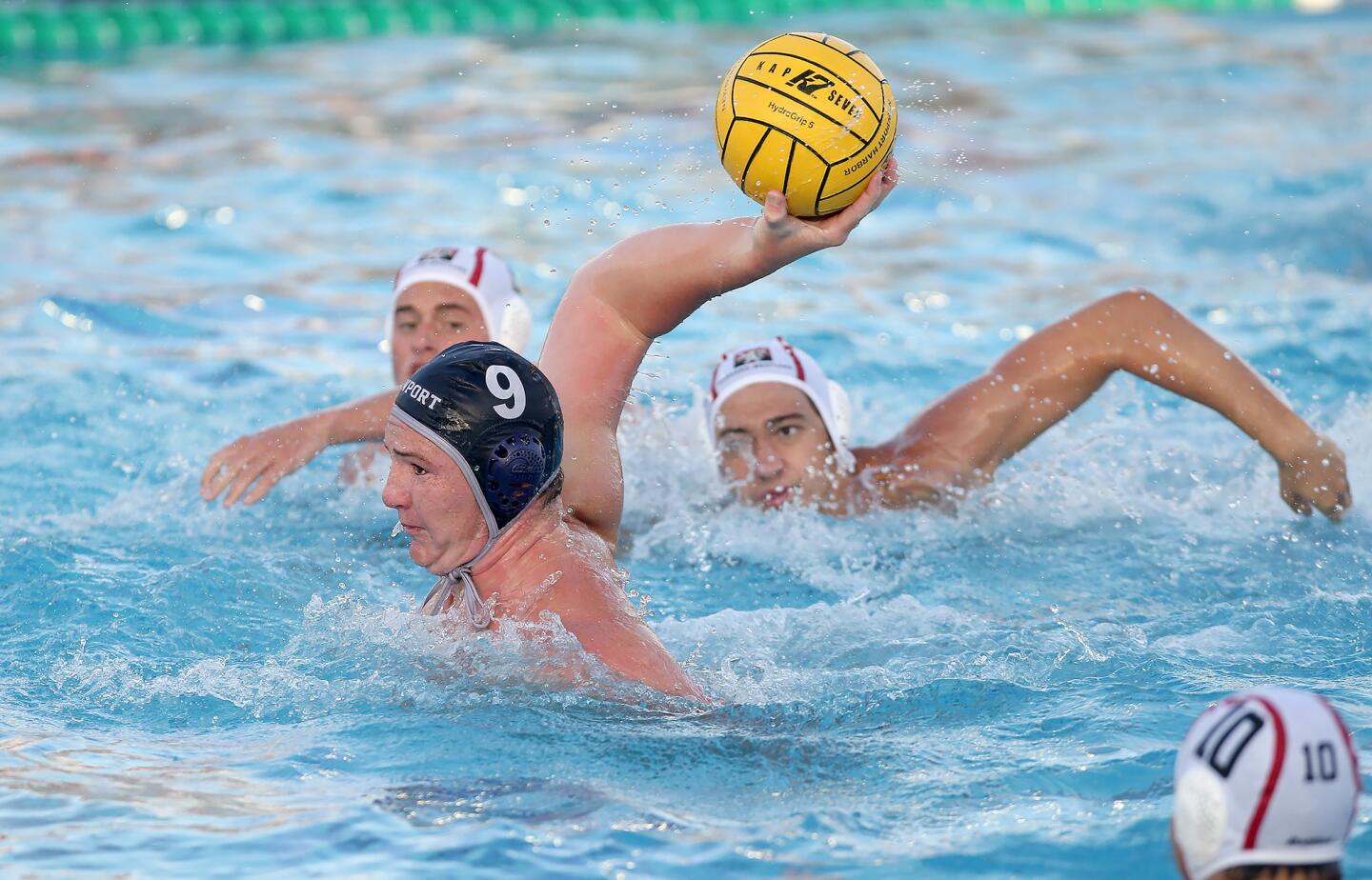 Newport Harbor High's Ike Love shoots and scores during boysâ€™ non league water polo match against Studio City Harvard-Westlake on Saturday.