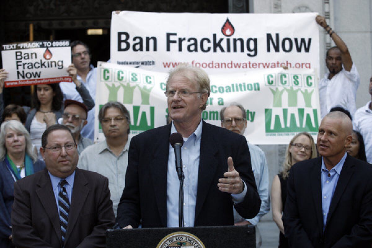 Actor and environmental activist Ed Begley Jr., flanked by Los Angeles City Councilmen Paul Koretz, left, and Mike Bonin, speaks at a news conference on the City Hall steps in support of a ban on fracking in Los Angeles.