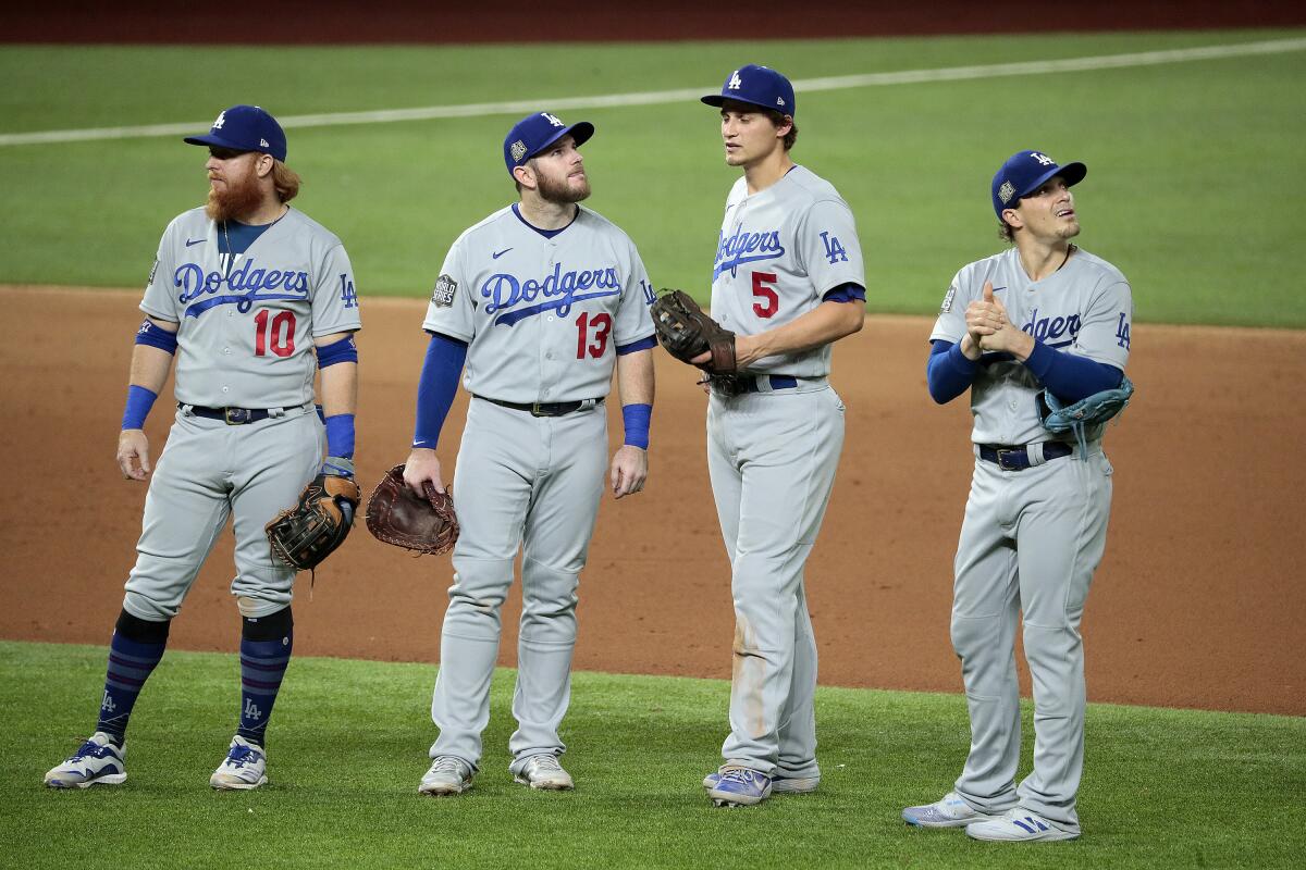 Dodgers infielders meet near the mound during a pitching change.