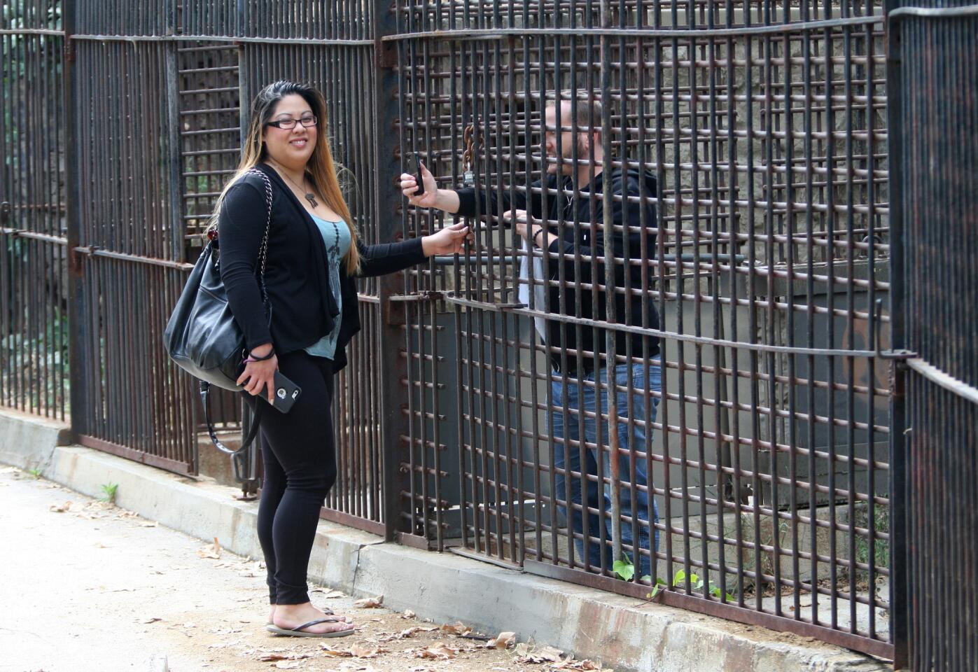 Chandra Chang of Culver City, left, and Jamie McCormick of Los Angeles have fun while visiting the old Los Angeles Zoo cages during a three-hour, Red Carpet tour offered by Burbank-based Sunnyday Scoot on Friday, June 5, 2015.