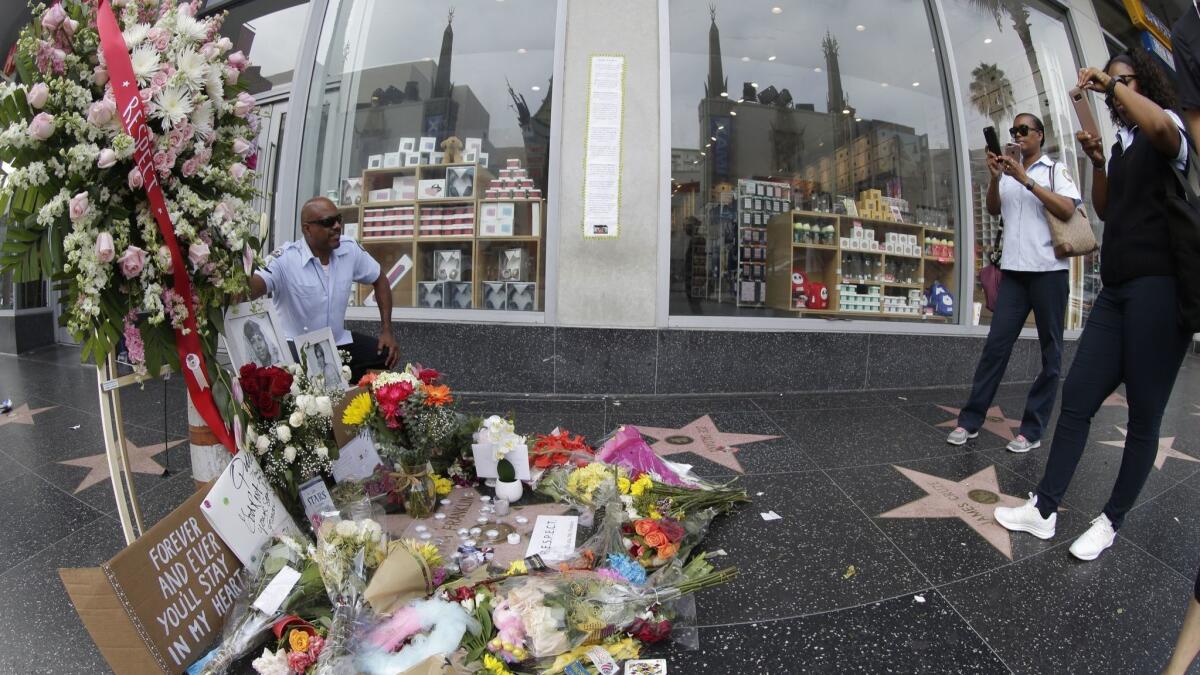 Fans pay their respects to singer Aretha Franklin at her star on the Hollywood Walk of Fame.